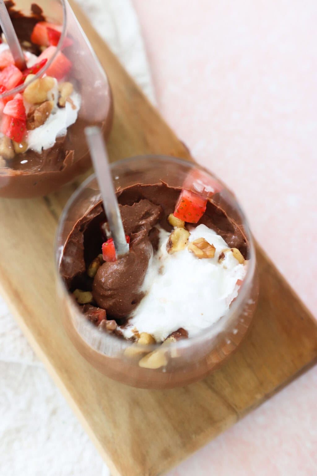 5-Minute Cottage Cheese Chocolate Mousse in two glass cups with strawberries and walnuts