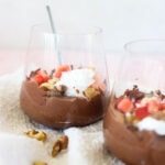 5-Minute Cottage Cheese Chocolate Mousse in two glass cups with strawberries and walnuts